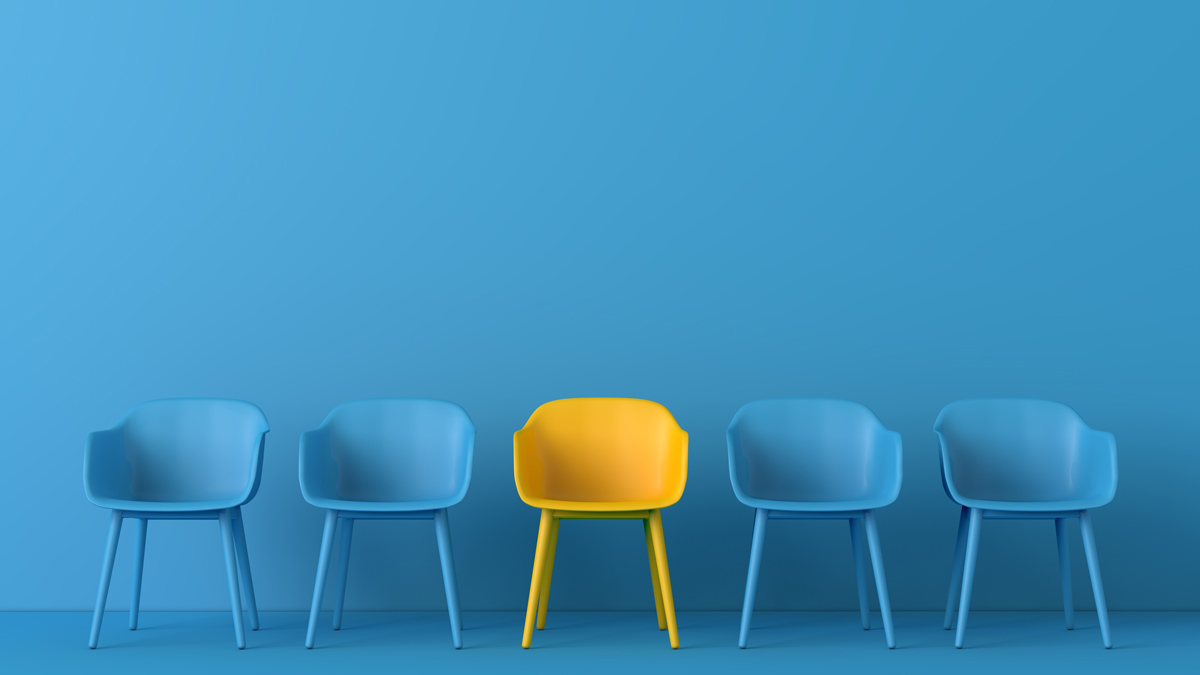 a row of blue chairs with one yellow chair in the center against a blue wall showcasing modern design and color contrast in furniture
